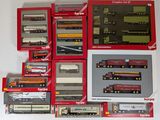 a lot of different model trains in boxes on the table