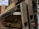 a pile of wood and a sign on the wall