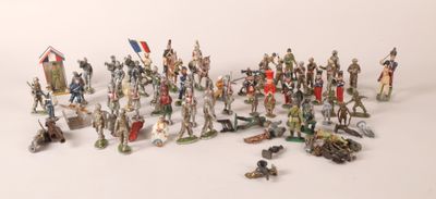 many figurines of different sizes and colors on a white surface