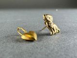 a gold earring with a dog and a heart on it