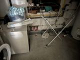 an image of a dirty room with a washing machine and a dryer