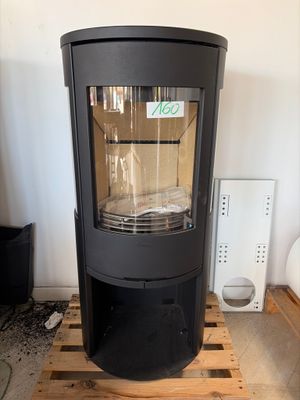 a black stove sitting on a pallet in a room