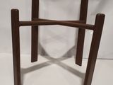 a close up of a wooden chair on a white surface