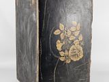 a black box with a gold leaf design on it