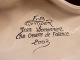 a close up of a white vase with a black writing on it