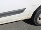 a white car that is parked on the side of the road