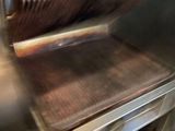 a close up of a grill with a grilling pan in it