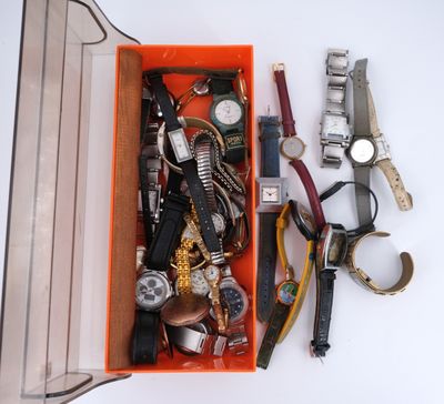 an orange box filled with assorted watches and other items