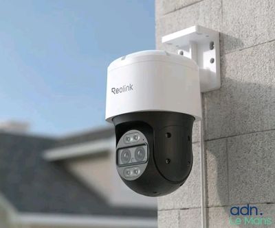 a close up of a camera mounted on the side of a building