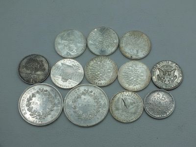 a lot of silver coins sitting on a table