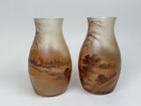 two vases that are sitting on a white surface