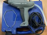 a close up of a corded hot glue gun on a table