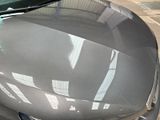 a close up of a car that is parked in a parking lot