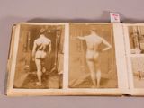 an old photo of a naked woman standing in front of a doorway