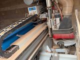 a machine that is working on a piece of wood