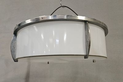 a white light hanging from the ceiling in a room