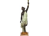 statue of a woman holding a candelab with a candelab in the background