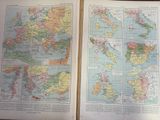 two maps of europe and the middle east are open on a table