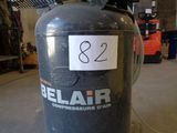 a black cylinder with a label on it in a warehouse