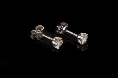 une paire de boucles d'oreilles en argent sur fond noir