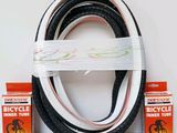 three different types of bicycle tires and a box of toothpaste
