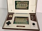 a small game console with a game on the screen