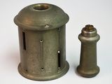 a small metal object sitting next to a smaller metal object