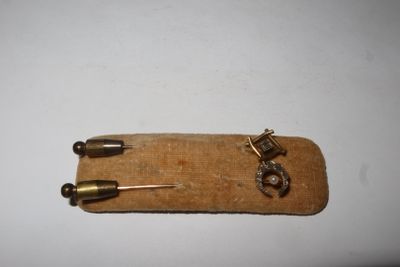 a small piece of wood with a small metal object on it