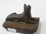 a statue of a dog that is sitting on a box