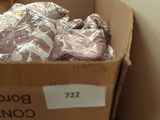 a cardboard box with a bunch of clothing in it