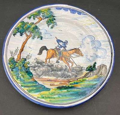 a plate with a painting of a horse and rider on it