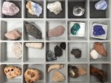 many different types of rocks in a plastic box