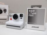 a polaroid camera sitting on a table next to a box