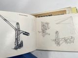 an open book with drawings of a crane on it