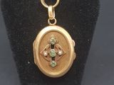a close up of a gold locke with a cross on it