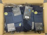 four pairs of men ' s socks in a box