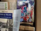 books in a cardboard box on a table in a room