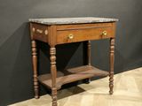a wooden table with a marble top on a wooden floor