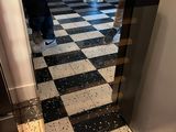 a person standing in front of a black and white checkered floor