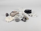 a pile of rocks and crystals on a white surface