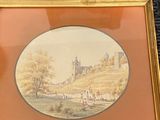 two framed pictures of a landscape with a church in the background