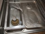a metal pan with a strainer and a strainer in it