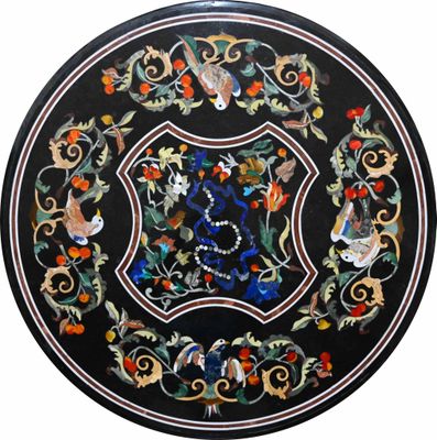 a close up of a black table with a floral design on it
