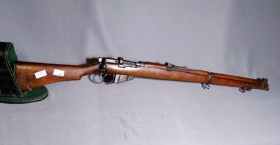 an old wooden rifle with a green hat on a white background