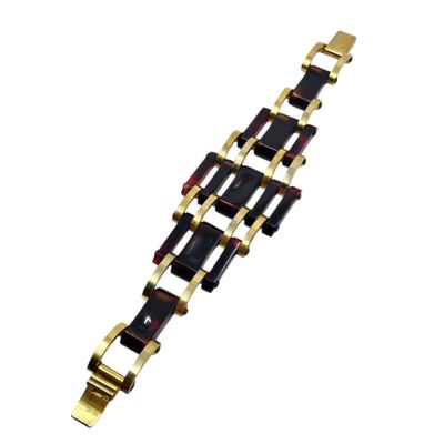 a close up of a gold and black bracelet on a white background