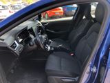 the interior of a blue car with black seats and a steering wheel