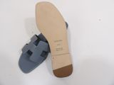 a close up of a pair of blue sandals on a white surface
