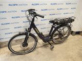 a bicycle that is parked in front of a wall
