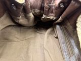 a brown purse that is open on the floor