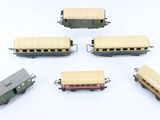 several toy train cars are arranged in a circle on a white surface